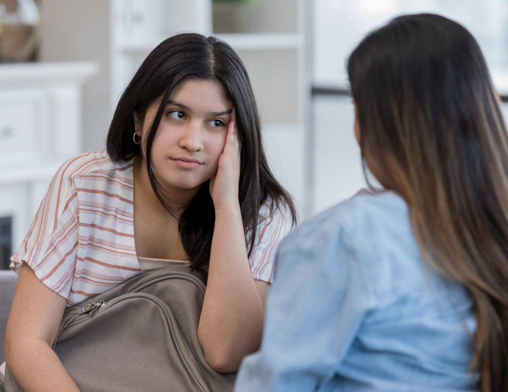 Parent having an open conversation with their teenage child about boundaries, consent, and healthy relationships.