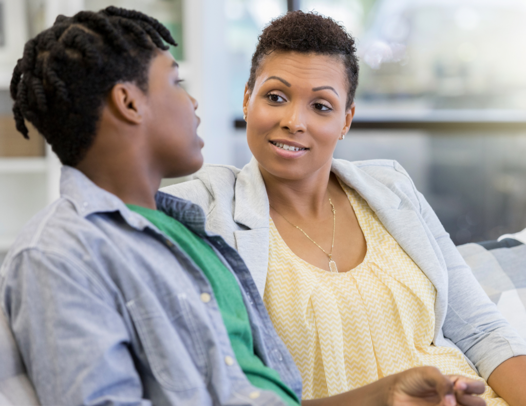 Teenager listening during a discussion about consent, communication, and healthy relationship skills with a parent.